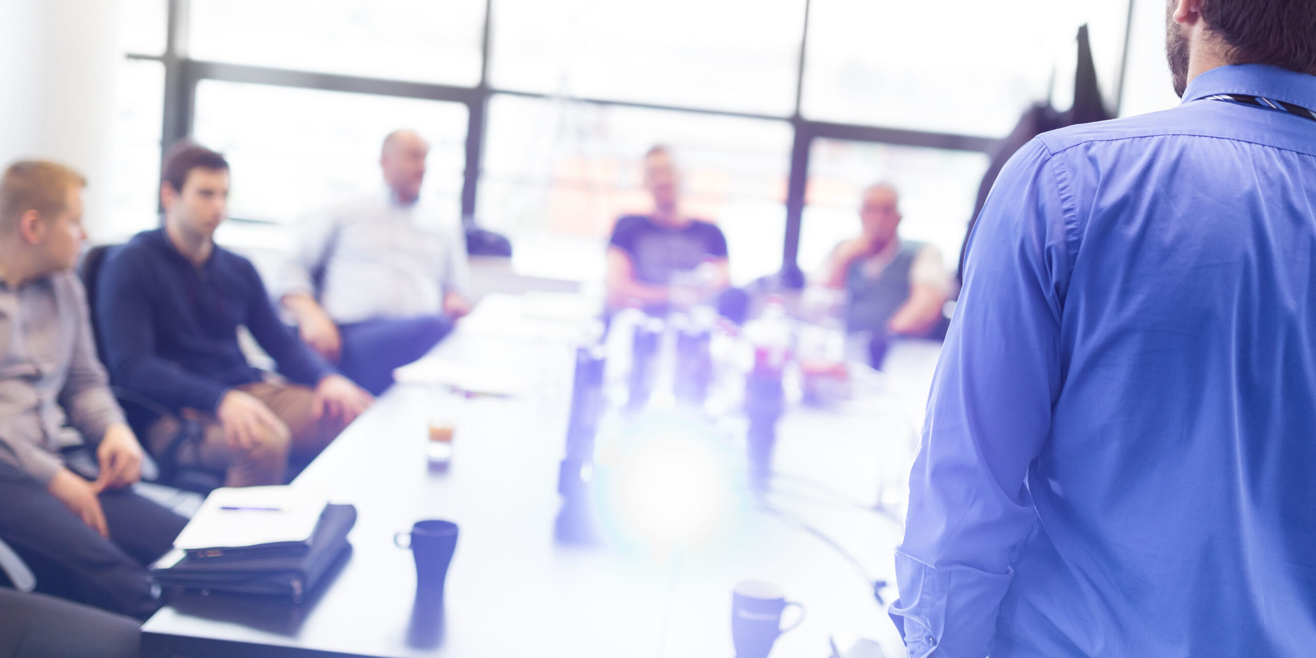 People sat round a table in a training meeting